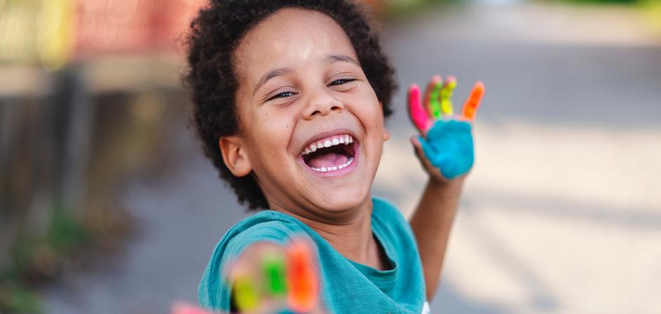 child with paint on hands