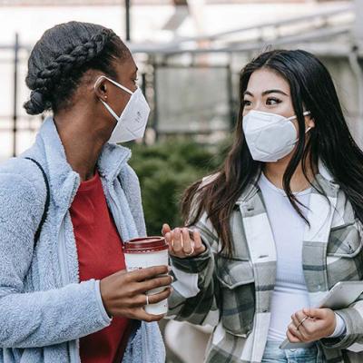 Two teenage girls wearing masks