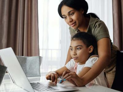 mother and daughter looking at laptop