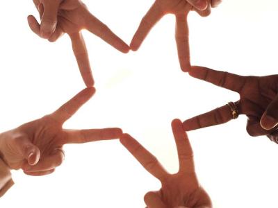 people forming star with hands