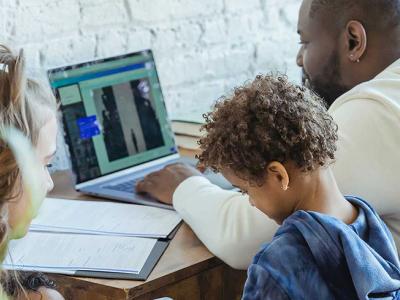 Family with dad working at desk